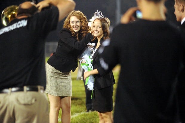 Homecoming court member Ashley Matta, left, crowns Sidney Weber Riversides 2013 Homecoming Queen. Photo by Dave Miller for The Times