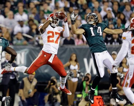 Kansas City Chiefs' Sean Smith (27) intercepts a pass intended for Philadelphia Eagles' Riley Cooper (14) during the first half of an NFL football game, Thursday, Sept. 19, 2013, in Philadelphia.