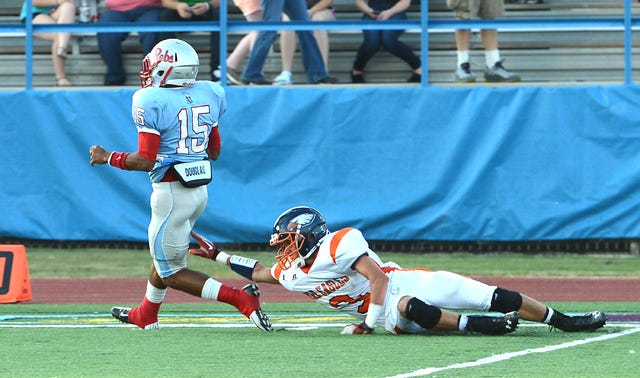 BRIAN D. SANDERFORD • TIMES RECORD / Southside running back D'erek Fernandez, left, is forced out of bounds by Rogers Heritage's James Moreland on Friday, Sept. 6, 2013, at Jim Rowland Stadium. Southside won the game 44-28.