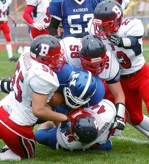 A group of Binghamton defenders take down Horseheads ball carrier Nick Zeggert. Eric Wensel/The Leader