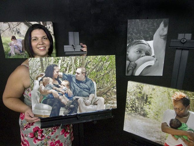 Lakeland photographer Christine Santos, 29, displays some of her work from her upcoming exhibition entitled "Nursing Is Natural... Naturally Beautiful," at Paint Along Studios in downtown Lakeland Friday. July 26, 2013. The show opens at Paint Along Studios on September 20.