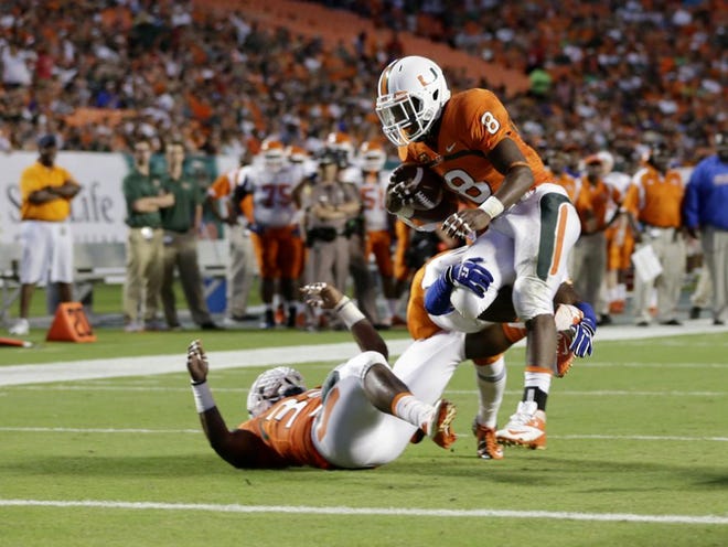 Miami 's Duke Johnson runs in for a touchdown during the first half of an NCAA college football game against Savannah State, Saturday, Sept. 21, 2013, in Miami Gardens, Fla. (AP Photo/Lynne Sladky)