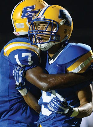 Eastern Guilford's Yrral Davis, right, celebrates with teammate Jarius Morehead after Davis' touchdown during Friday night's game against Northeast Guilford.