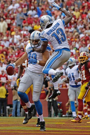 Detroit Lions tight end Joseph Fauria celebrates his touchdown reception with wide receiver Nate Burleson (13) during the first half of a NFL football game against the Washington Redskins in Landover, Md., Sunday, Sept. 22, 2013.
