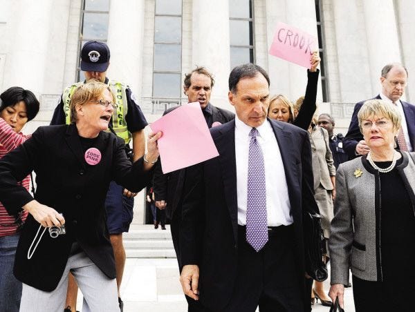 ** FOR USE SUNDAY, SEPT. 6 AND THEREAFTER ** FILE - In this Oct. 6, 2008 file photo, Lehman Brothers Holdings Inc. Chief Executive Richard S. Fuld Jr., front center, is heckled by protesters as he leaves Capitol Hill in Washington after testify before the House Oversight and Government Reform Committee on the collapse of Lehman Brothers. (AP Photo/Susan Walsh, file)