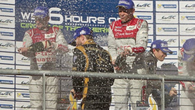 The winners in the top four overall spots of the six-hour endurance race at Circuit of the Americas shower one another with champagne in celebration.