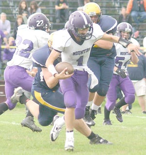 Little Falls quarterback Brian Ewanyk runs with Notre Dame defenders in pursuit during the second half of Saturday's game.



Times Photo/Jon Rathbun