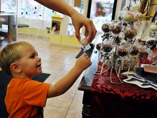 Two-year-old Gauge Winkle picks out Halloween candy at Got Candy shop on Kentucky Avenue in downtown Lakeland last year.