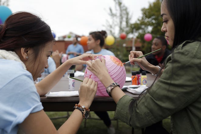Thao Dao, left, and Jill Truong make a lantern during the Asian Moon Festival at the University of Central Oklahoma. PHOTO BY SARAH PHIPPS, THE OKLAHOMAN. SARAH PHIPPS - THE OKLAHOMAN