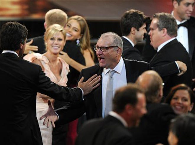 Ed O'Neill, center, and Julie Bowen, second left, and the rest of the cast and crew of "Modern Family" stand to accept the award for outstanding comedy series at the 65th Primetime Emmy Awards at Nokia Theatre on Sunday Sept. 22, 2013, in Los Angeles.