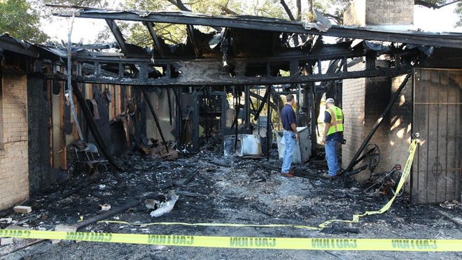 Investigators examine the aftermath of an early morning fire at a Northeast Austin duplex that displaced six people.