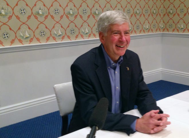 In this Sept. 20, 2013 photo, Michigan Gov. Rick Snyder speaks during a news conference hosted by Michigan Republicans on Mackinac Island, Mich. Before an audience of top Michigan and national Republicans, the former CEO, called "nerd" by himself and his staff, talked about a list of accomplishments he said Congress can only dream of, and promoted what he described as problem-solving style.