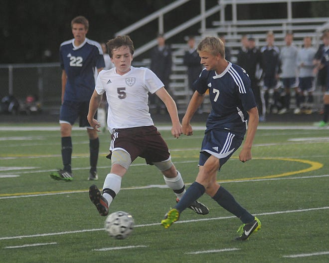 Unity's Christian's Trent Vegter (7) passes the ball as Holland Christian's Bryce Eggers (5) defends Monday afternoon.