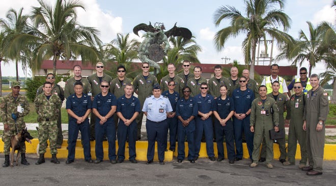 Members of the VP-10 "Red Lancers" gather with members of the Columbian air force during UNITAS 2013, an annual multinational maritime exercise sponsored by U.S. Southern Command and hosted by the Colombian navy this year. At center is Col. David Barrero of the Colombian air force, the airfield commander for Comando Aero Combato No. 3, which supported the Red Lancers at the Barranquilla Airfield in Colombia.