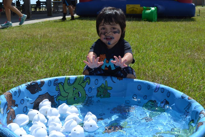 Two-year-old Michael Estrada enjoys playing in the "Go Fish" pool at the "Day for Kids" event sponsored by MWR and Boys & Girls Clubs on Saturday at the Sea Otter Pavilion.