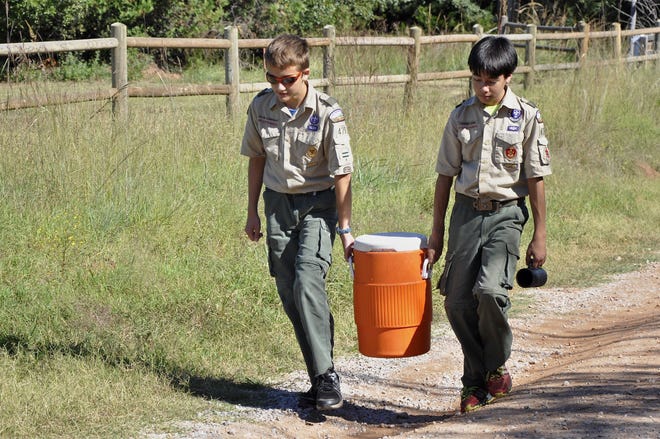 Jacob Garbrecht and Thomas Hara, both of Edmond, carry water to their camp during a Webelos campout on Sept. 21 in Oklahoma City. Photo by M. Tim Blake, for The Oklahoman