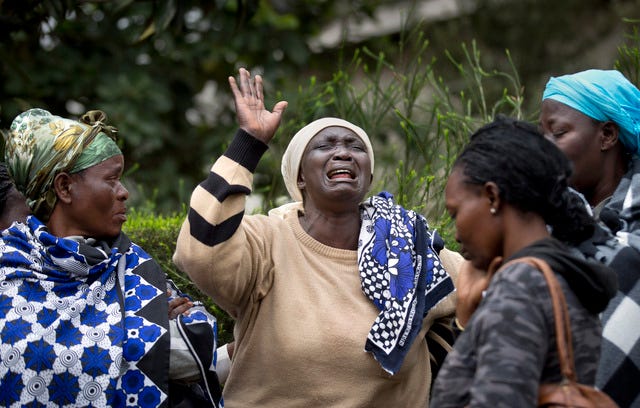 Mary Italo, center, grieves with other relatives for her son Thomas Abayo Italo, 33, who was killed in the Westgate Mall attack, as they wait to receive his body at the mortuary in Nairobi, Kenya Wednesday, Sept. 25, 2013. Thomas was an accountant and the breadwinner of the family who helped look after Mary who is sick, according to relatives. Kenyan authorities prepared for the gruesome task of recovering dozens more victims than initially feared after the country's president declared an end Tuesday to the four-day siege of the Nairobi mall by al-Qaida-linked terrorists. (AP Photo/Ben Curtis)