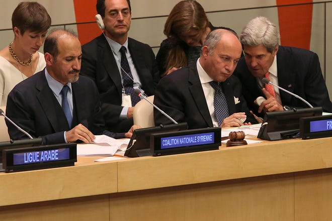 President of the Opposition Syrian Coalition, Ahmad Jarba, left, French Foreign Minister Laurent Fabius, center, and American Secretary of State John Kerry attend a Ministerial Meeting of the Group of Friends of the Syrian people, Thursday, Sept. 26, 2013 at United Nations headquarters. (AP Photo/Mary Altaffer)