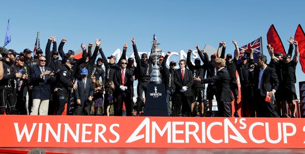 Members of Oracle Team USA celebrate with the Auld Mug after winning the America's Cup sailboat race over Team New Zealand in San Francisco on Wednesday.