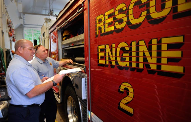 Columbia firefighters Rich Harris, left, and Dan Berlemann take inventory of one of the firetrucks at Station 2, 1212 W. Worley St. The station does not always have six firefighters on duty, leaving it understaffed the majority of the time.