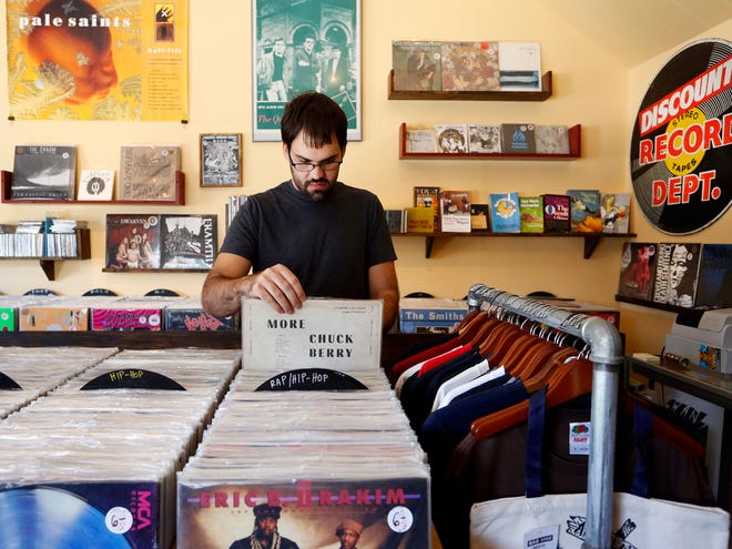Ryan Williams sorts through vinyl records recently at Arrow’s Aim Records at 101 N. Main St. On Sunday, Arrow’s Aim hosts the inaugural Gainesville Record Fair at The Wooly, 40 N. Main St., where 25 vendors will buy and sell LPs and 45s.