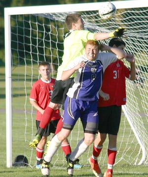 Vernon-Verona-Sherrill goalkeeper Justin VanDuLuitgaarden (top) bats the ball away from the head of West Canada Valley Indian Chase Roesler on a corner kick late in the second half of Wednesday’s match. 



Times Photo/Jon Rathbun