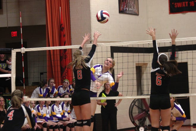Sophomore middle hitter Lilly Pickett smashes a kill during the first set against Hartem. Mount Pulaski won in two sets.