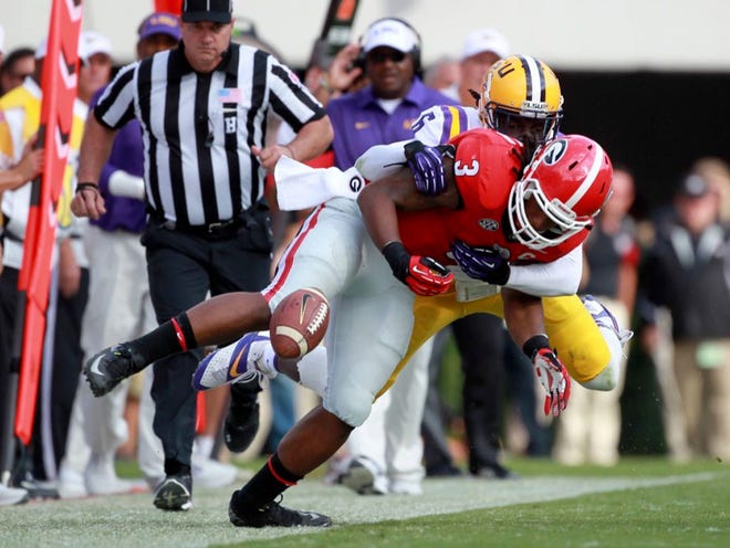 Georgia tailback Todd Gurley (3) fumbles the ball and is tackled by LSU safety Craig Loston on a long run in the first half of an NCAA college football game on Saturday, Sept. 28, 2013, in Athens, Ga. The ball rolled out of bounds and Georgia kept possession but Gurley was hurt on the play. (AP Photo/Atlanta Journal-Constitution, Jason Getz )