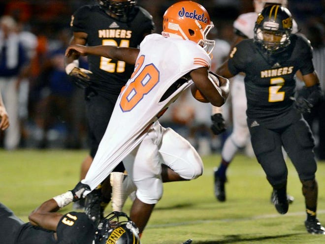 Fort Meade's Ladarius Clark (13) hangs on to the jersey of Bartow's Jabray Chisolm (28) during their game at Frank S. Battle Field in Fort Meade on Friday.