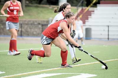 Photo courtesy of Montclair State University Newton High grad Emily Burd takes the ball away from an opposing player as a defender for Montclair State field hockey team.