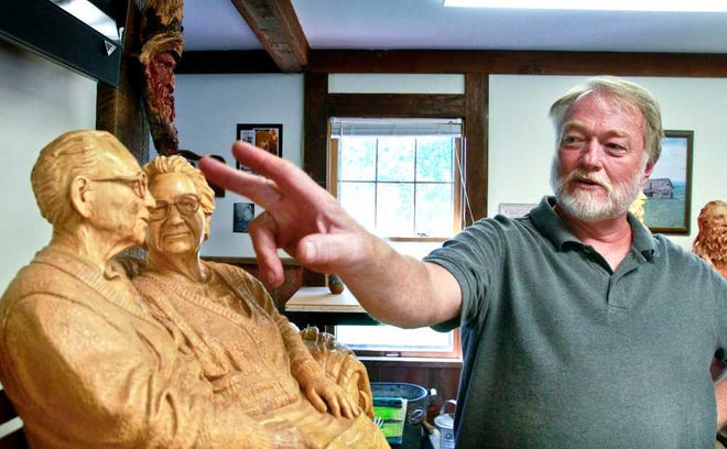 Holton artist Gerald Copeland describes how he created the finely carved details on "Lifetime of Love," a woodcarving depicting his wife's grandparents, the late Catherine and Earl Christman, of Topeka. The piece, carved from a solid piece of laminated basswood, is displayed in Copeland's studio in Holton.