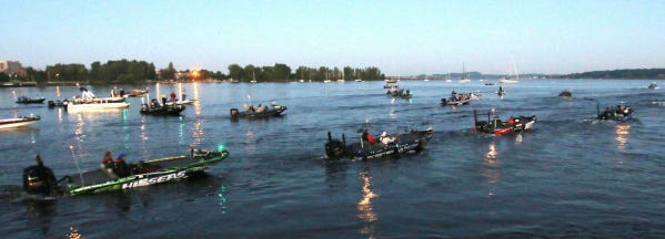 Professional fishermen head out on Muskegon Lake on Friday for the first day of competition in the Bassmaster Elite Series tournament in Muskegon, Mich.