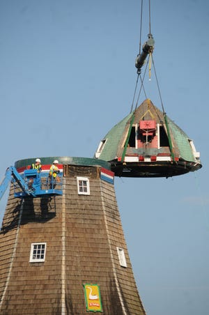 The cap of the DeZwaan Windmill is carefully removed Tuesday morning as repairs to the windmill continue on Windmill Island.