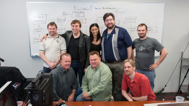 Chris Roberts ( second from left on top row), the creator of the famous " Wing Commander" video game is launching a new game, "Star Citizen". Appearing with Roberts are ( left to right top row) Martin Galway, Sandi Gardiner, Ben Lesnick, Mike Nightingale, ( bottom row left to right) David Swofford, Eric Peterson and Dennis Heaney.