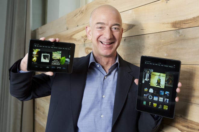 IMAGE DISTRIBUTED FOR AMAZON  In this image distributed on Tuesday, Sept. 24, 2013, Amazon.com Founder and CEO Jeff Bezos introduces the all-new Kindle Fire HDX 8.9'', right, and Kindle Fire HDX 7'' tablet in Seattle." ORG XMIT: INVL