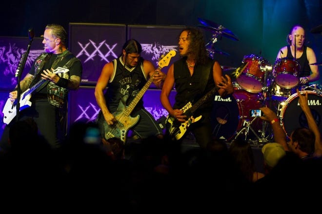 Metallica members, from left, James Hetfield, Robert Trujillo, Kirk Hammett and Lars Ulrich perform at a private concert for SiriusXM listeners at the Apollo Theater on Saturday, Sept. 21, 2013 in New York. (Photo by Charles Sykes/Invision/AP)