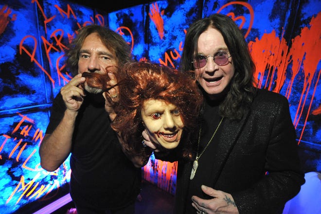Geezer Butler, left, and Ozzy Osbourne pose with props at the "Black Sabbath: 13 3D" maze at Universal Studios Halloween Horror Nights, in Universal City, Calif. Several spooks at this year's Halloween Horror Nights are hyping new releases from the entertainment industry. Besides "13" from Sabbath, there's a "scare zone" populated by actors dressed as the nasty Chucky doll from the direct-to-DVD sequel "Curse of Chucky," and a new maze incorporating supernatural elements from the "Insidious" films.