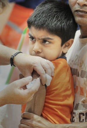 (FILE PHOTO) Harish Kchitty gets a flu shot during an open house for free flu vaccines held at Harry S. Truman High School in Bristol Township in 2013.