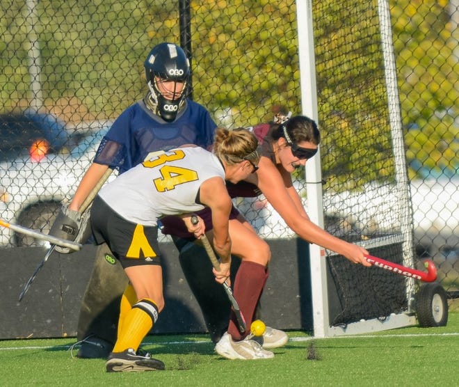 Bordentown's Jess Carey shoots around a Holy Cross defender and goalie for the winning goal during the Bordentown Vs Holy Cross Field Hockey game played on Wednesday, October 2, 2013 in Bordentown, NJ