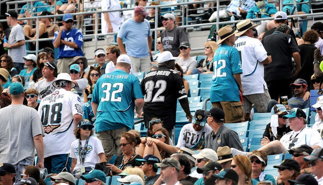 Fans leave at the end of the third quarter of the Jacksonville Jaguars 37-3 loss to the Indianapolis Colts in an NFL game in Jacksonville, Fla., Sunday, Sept. 29, 2013. (AP Photo/The Florida Times-Union, Bruce Lipsky )