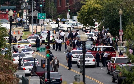 This view from the Russell Senate Office Building shows police converging on the scene of a shooting on Constitution Avenue on Capitol Hill near the Supreme Court in Washington on Thursday. (Associated Press photo)