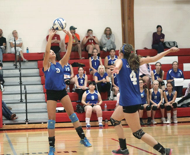 Brooke Cooper (9) sets up a ball for Michaeala Ultz against Colon on Thursday night.