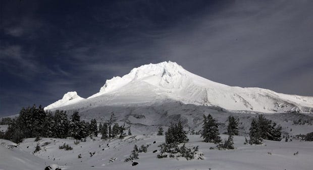 Clouds lift briefly and allow the sun to highlight Mount Hood wearing a fresh coat of snow. Heavy, winter-like storms passed through the state over the last several days.