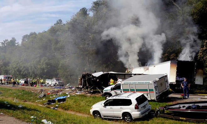 Emergency personnel search the scene Wednesday near a deadly collision involving a bus on Interstate 40 in Dandridge, Tenn.