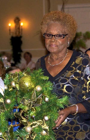 Barbara Vickers displays one of the wreaths made by various group who participate in the COA event each year. Contributed photo