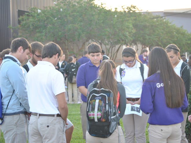 The Thibodaux High Christian Club held See You at the Pole Sept. 25 at the school. A group from the club prays together during the gathering.