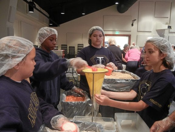 Millwood School Interact students are seen volunteering to assemble dried meals at Woodlake United Methodist Church in Chesterfield County. The meals will be sent to places in need.