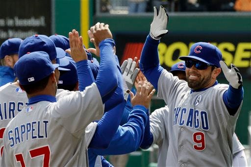 Chicago Cubs right fielder David DeJesus (9) celebrates with teammates after being introduced before a season opening baseball game against the Pittsburgh Pirates in Pittsburgh Monday, April 1, 2013.