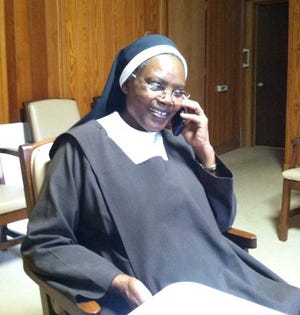 Submitted photo Sister Mary Catherine takes a call from Kenya.