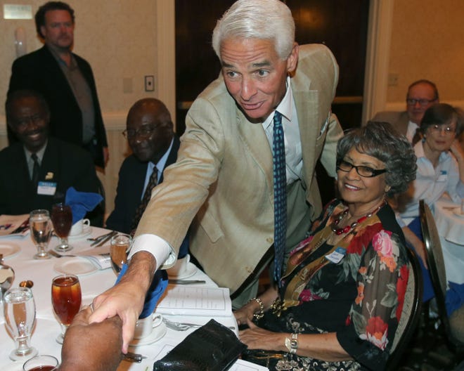 In this Sept. 8 photo, former Gov. Charlie Crist goes table-to-table greeting people during the 5th annual Marion County Democratic Club's "Proud to be a Democrat" dinner in Ocala. Crist looks like he is getting ready to run for his old job with his new party. Less than a year after registering as a Democrat, Crist has been traveling the state talking to Democratic groups.